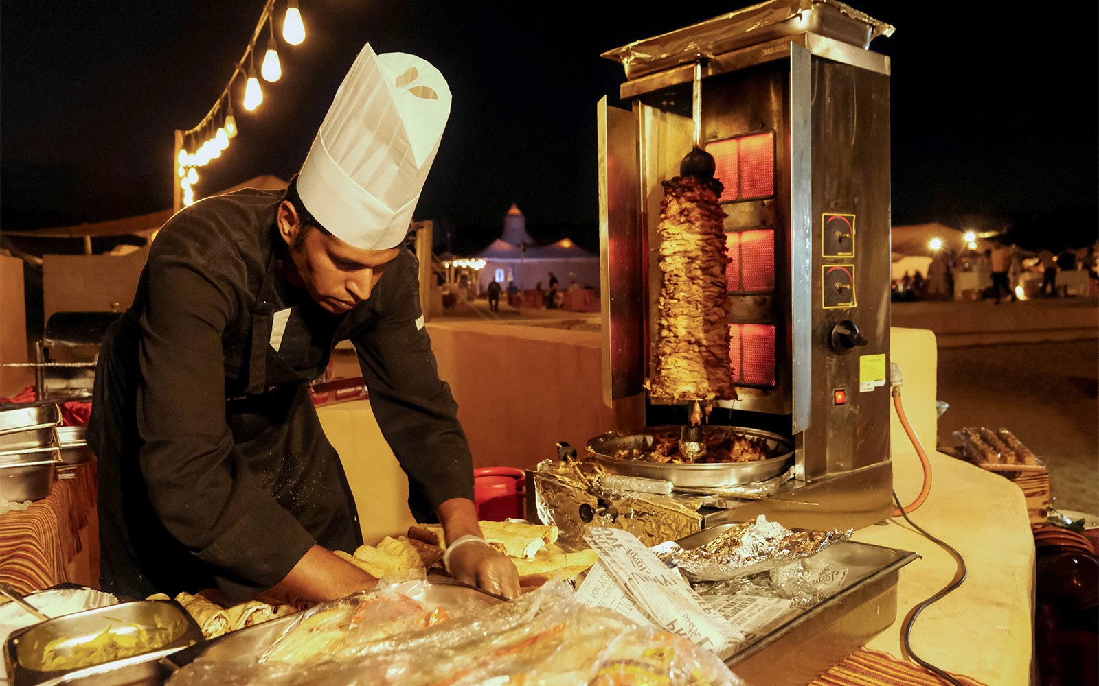 Chef preparing shawarma at a Dubai desert safari event.