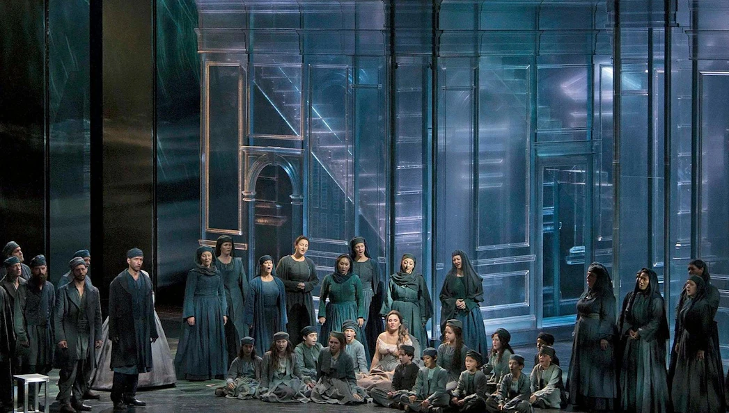 Cast performing Otello on Broadway stage with a modern set design.