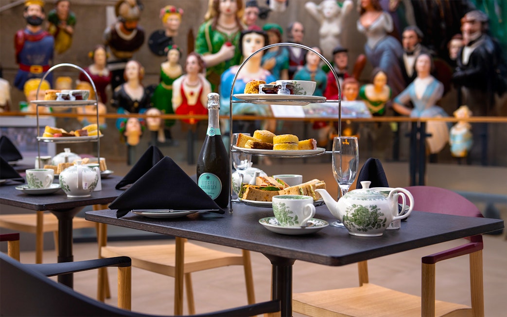 Afternoon tea setup with sandwiches and pastries at Cutty Sark, Greenwich.