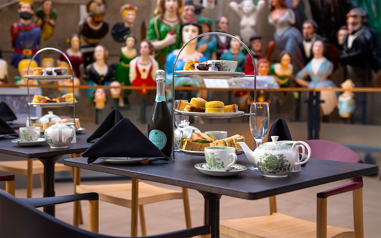 Afternoon tea setup with sandwiches and pastries at Cutty Sark, Greenwich.