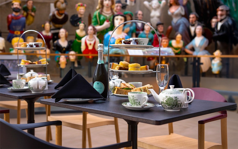 Afternoon tea setup with sandwiches and pastries at Cutty Sark, Greenwich.