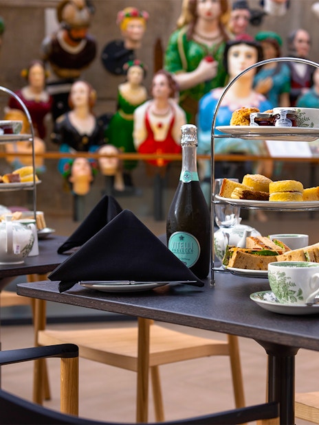 Afternoon tea setup with sandwiches and pastries at Cutty Sark, Greenwich.