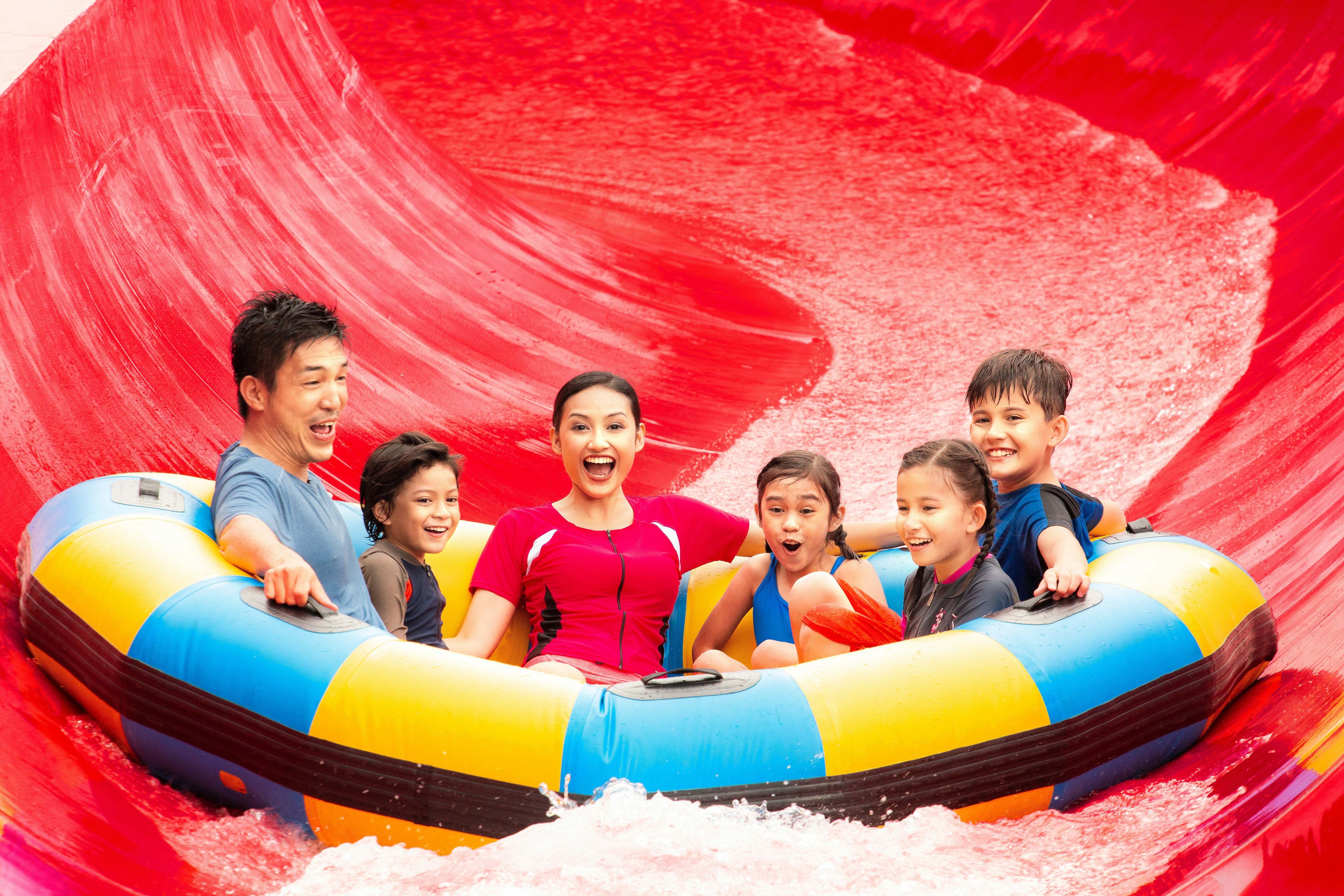 Family enjoying Red Rush ride at Legoland Malaysia water park.