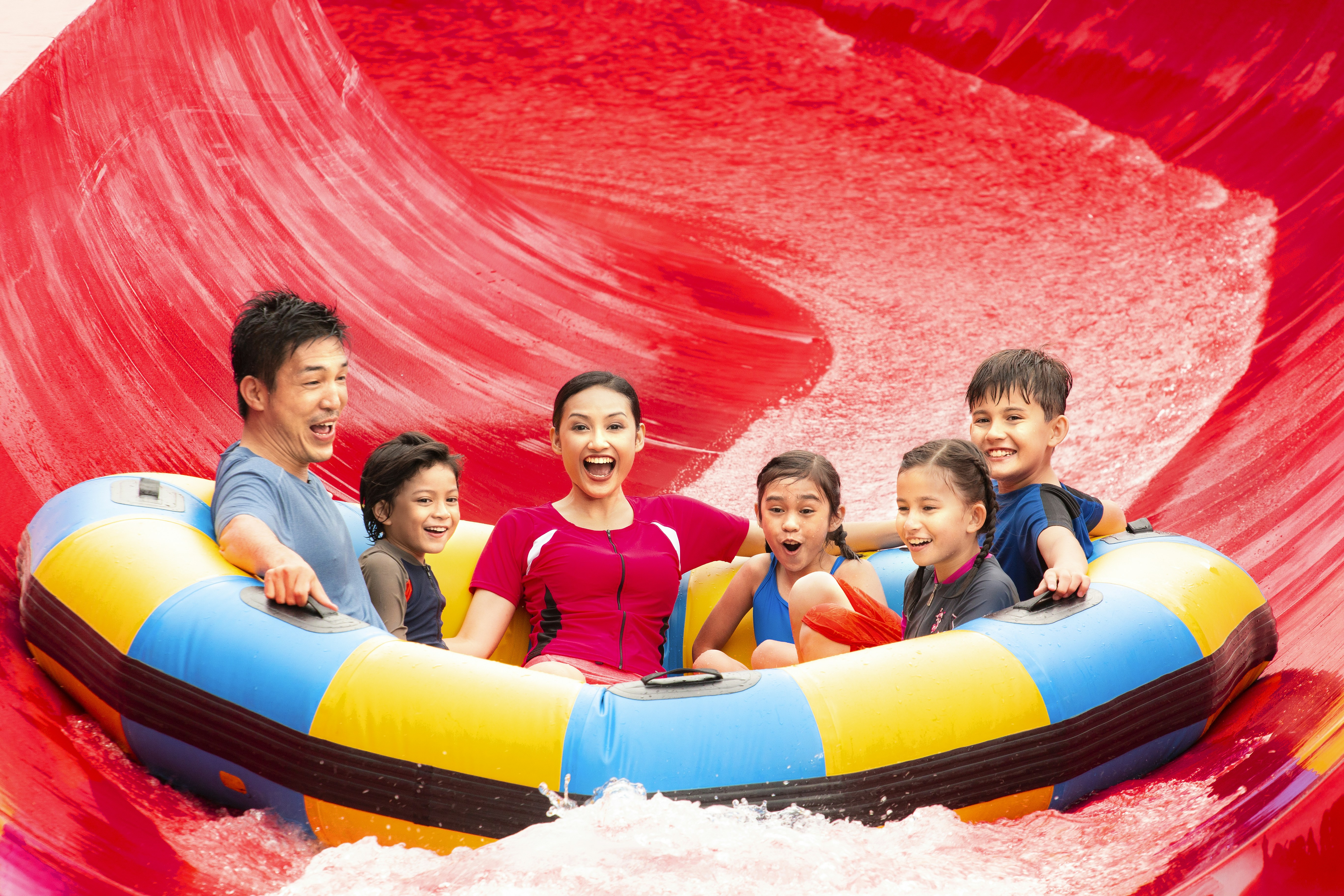 Family enjoying Red Rush ride at Legoland Malaysia water park.
