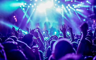 Friends dancing under bright lights at a nightclub.