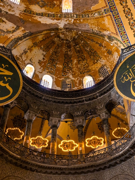 Hagia Sophia interior with Arabic calligraphy and ornate dome, Istanbul.