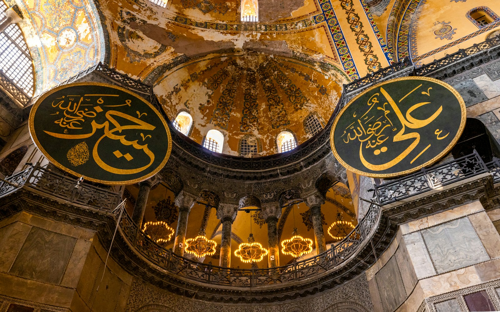 Hagia Sophia interior with Arabic calligraphy and ornate dome, Istanbul.