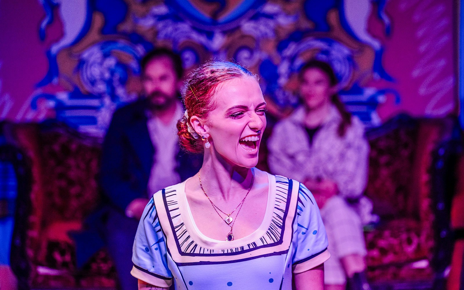 Performer in a vibrant stage scene from Plied and Prejudice show.