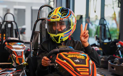 Person in colorful helmet driving a go-kart at Al Qana, Abu Dhabi.