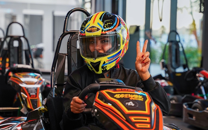 Person in colorful helmet driving a go-kart at Al Qana, Abu Dhabi.