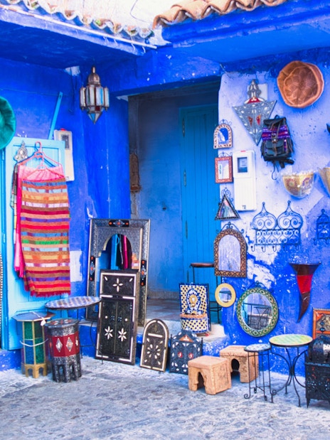 Souvenir shop with colorful textiles and crafts in Chefchaouen, Morocco's blue city.