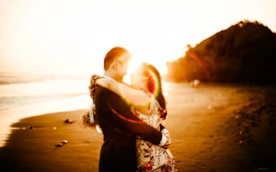 Couple embracing on a Lombok beach at sunset during a professional photoshoot.