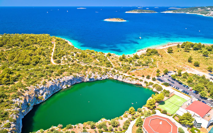 Aerial view of Dragon Eye Lake and turquoise coastline in Rogoznica, Croatia.