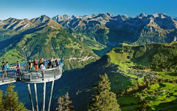 Visitors on a viewing platform overlooking Mount Stanserhorn's scenic landscape, Switzerland.