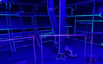 Industrial-themed room with neon blue lighting for self-guided experience.
