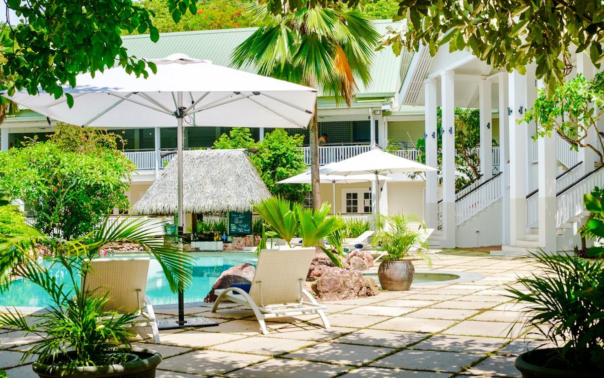 Lounge chair and umbrella by the pool at Malolo Island Resort, Fiji.