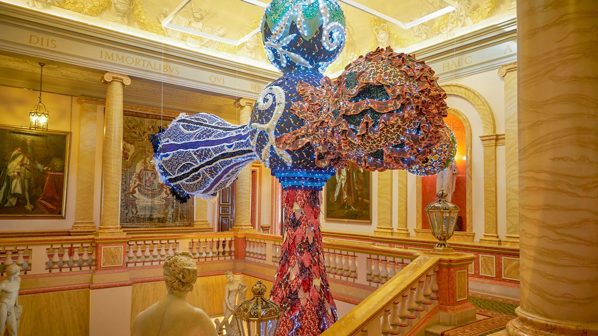 Liria Palace exterior with visitors using audio guides in Madrid, Spain.