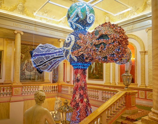 Liria Palace exterior with visitors using audio guides in Madrid, Spain.