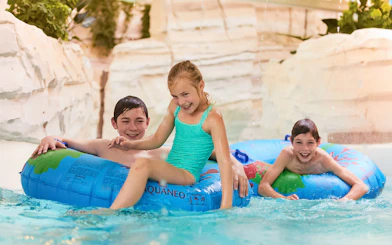 Children playing in jungle-themed water area at Bellewaerde Aquapark, Belgium.