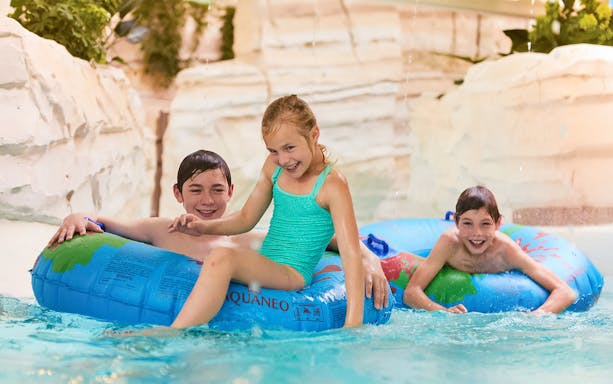 Children playing in jungle-themed water area at Bellewaerde Aquapark, Belgium.