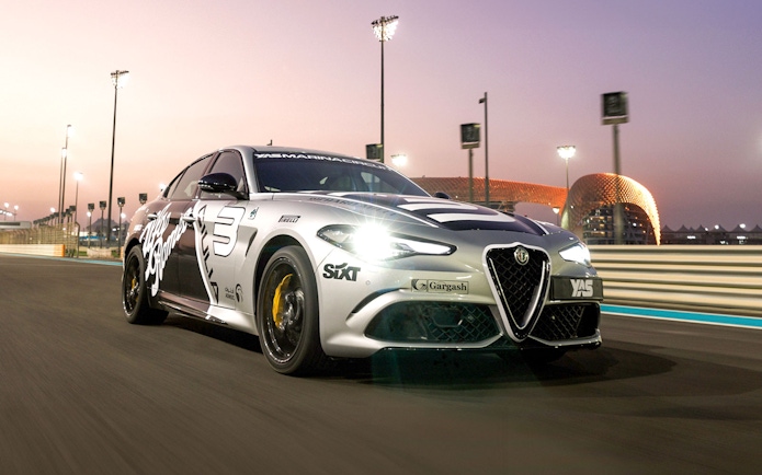 Alfa Romeo Giulia Quadrifoglio on Yas Marina Circuit at sunset.