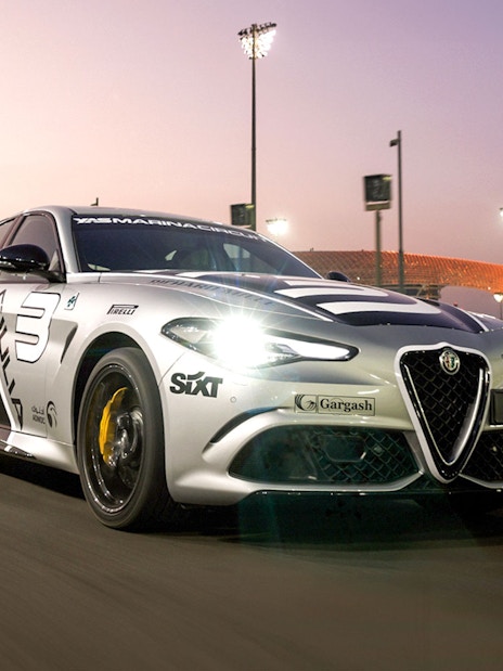 Alfa Romeo Giulia Quadrifoglio on Yas Marina Circuit at sunset.
