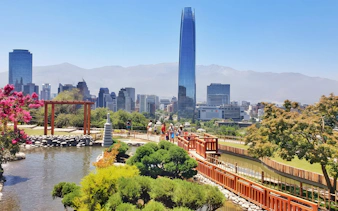 Jardín Japonés in Santiago with city skyline and Costanera Center in background.
