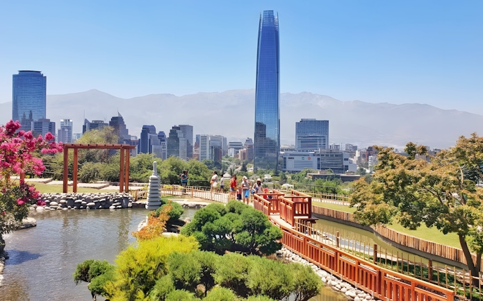 Jardín Japonés in Santiago with city skyline and Costanera Center in background.