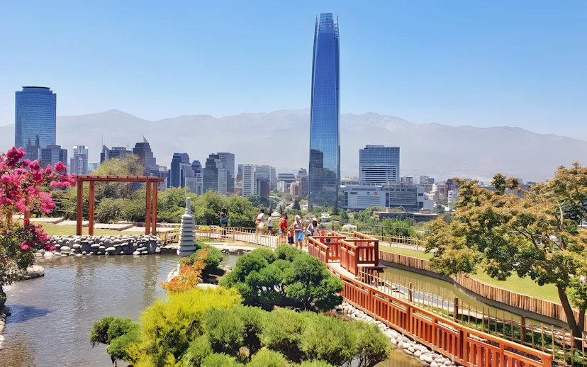Jardín Japonés in Santiago with city skyline and Costanera Center in background.