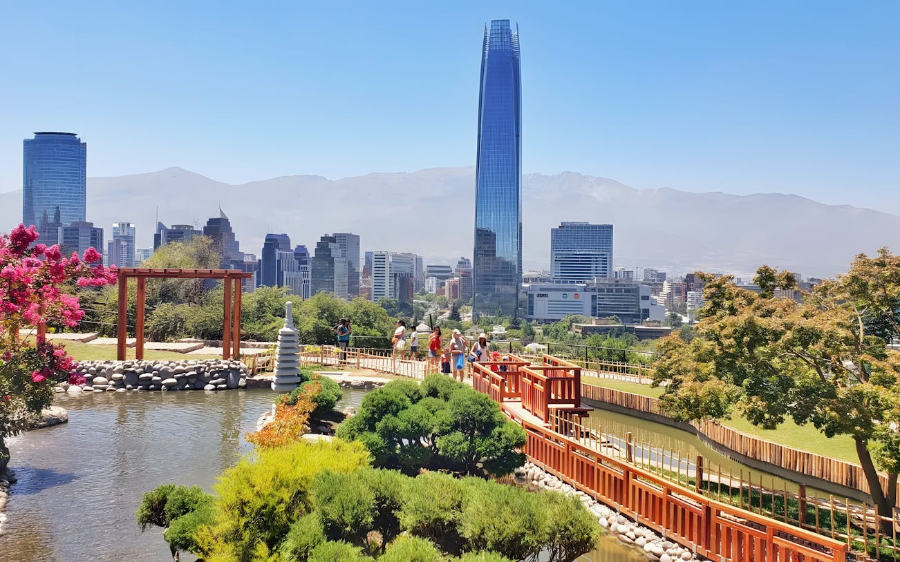 Jardín Japonés in Santiago with city skyline and Costanera Center in background.