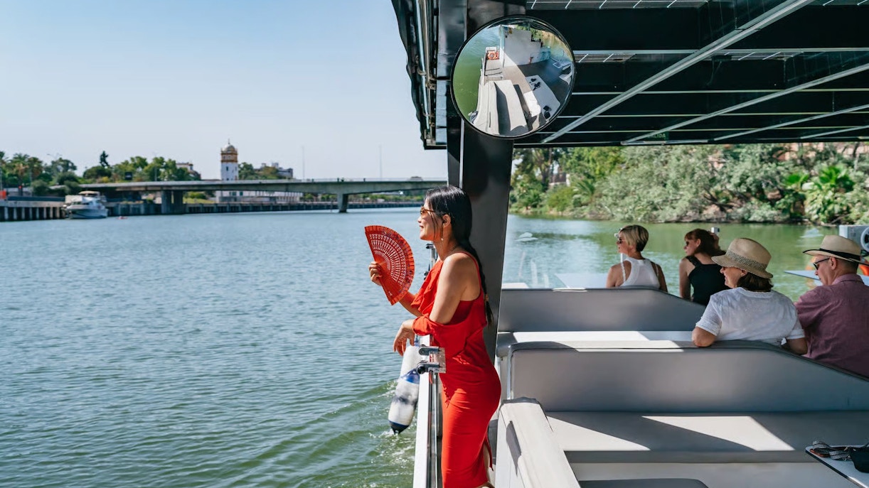 Tourists enjoying an Eco-Friendly Guadalquivir River Cruise in Seville, Spain.