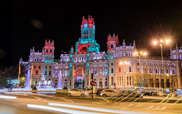 Cibeles Palace illuminated at night during Christmas, Madrid bus tour.