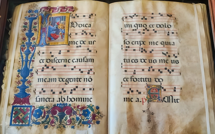 Illuminated manuscript with musical notation at Siena Duomo Complex.