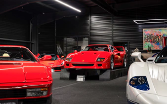 Red sports cars displayed at Coligny Car Museum, Lyon, France.