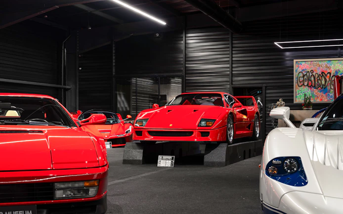 Red sports cars displayed at Coligny Car Museum, Lyon, France.