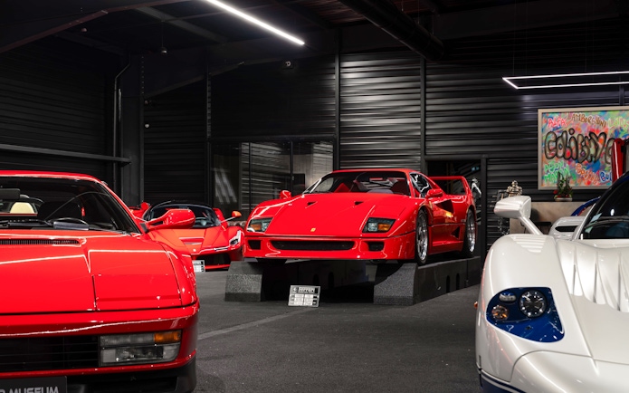 Red sports cars displayed at Coligny Car Museum, Lyon, France.