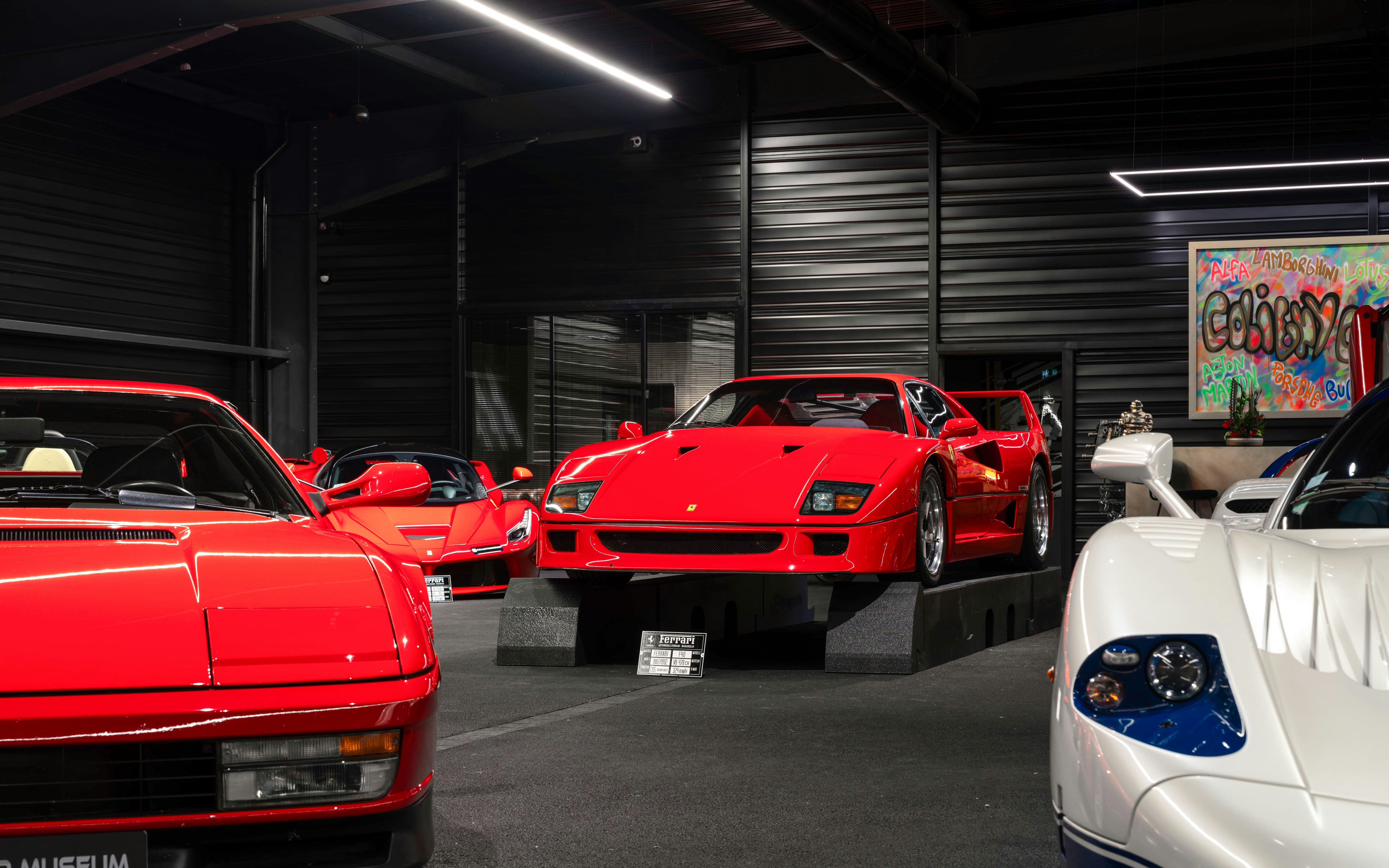 Red sports cars displayed at Coligny Car Museum, Lyon, France.