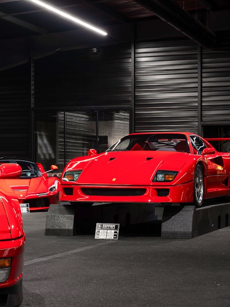 Red sports cars displayed at Coligny Car Museum, Lyon, France.