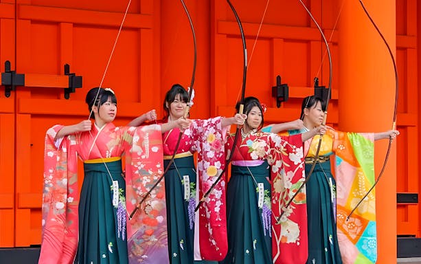 Women in traditional kimonos practicing archery in Kyoto during City of Culture tour.