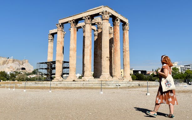 Temple of Olympian Zeus in Athens with visitor on audio tour.