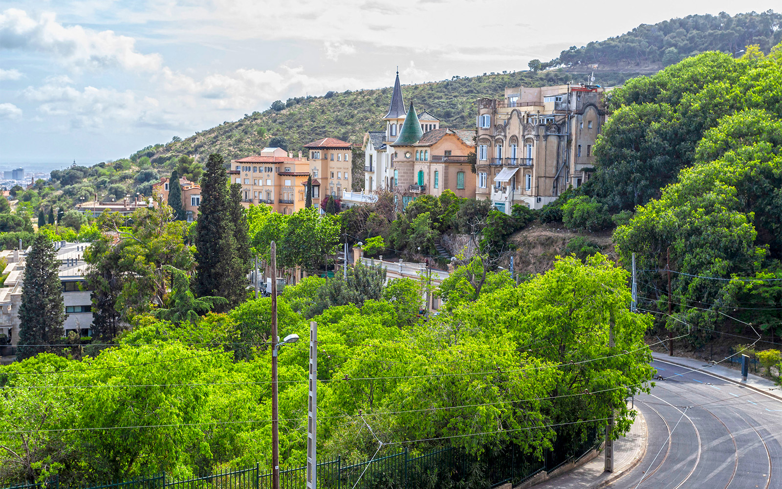 Tibidabo Avenue with view of Barcelona cityscape and iconic Tibidabo Amusement Park.