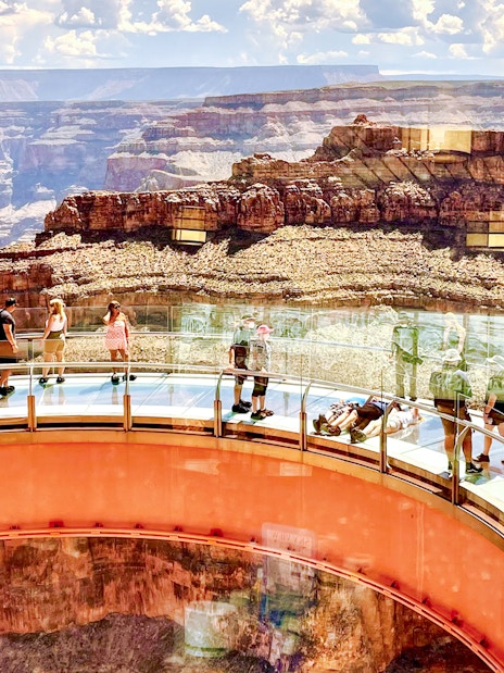 Visitors walking on the Grand Canyon Skywalk with canyon views in Arizona.