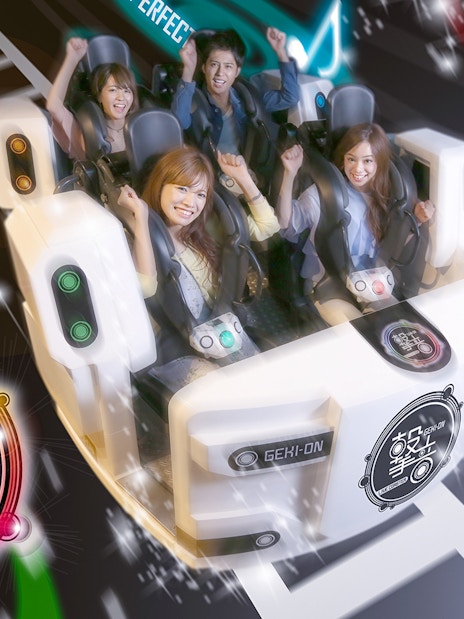Thrill-seekers enjoying an indoor roller coaster at Tokyo Joypolis Theme Park, Japan.