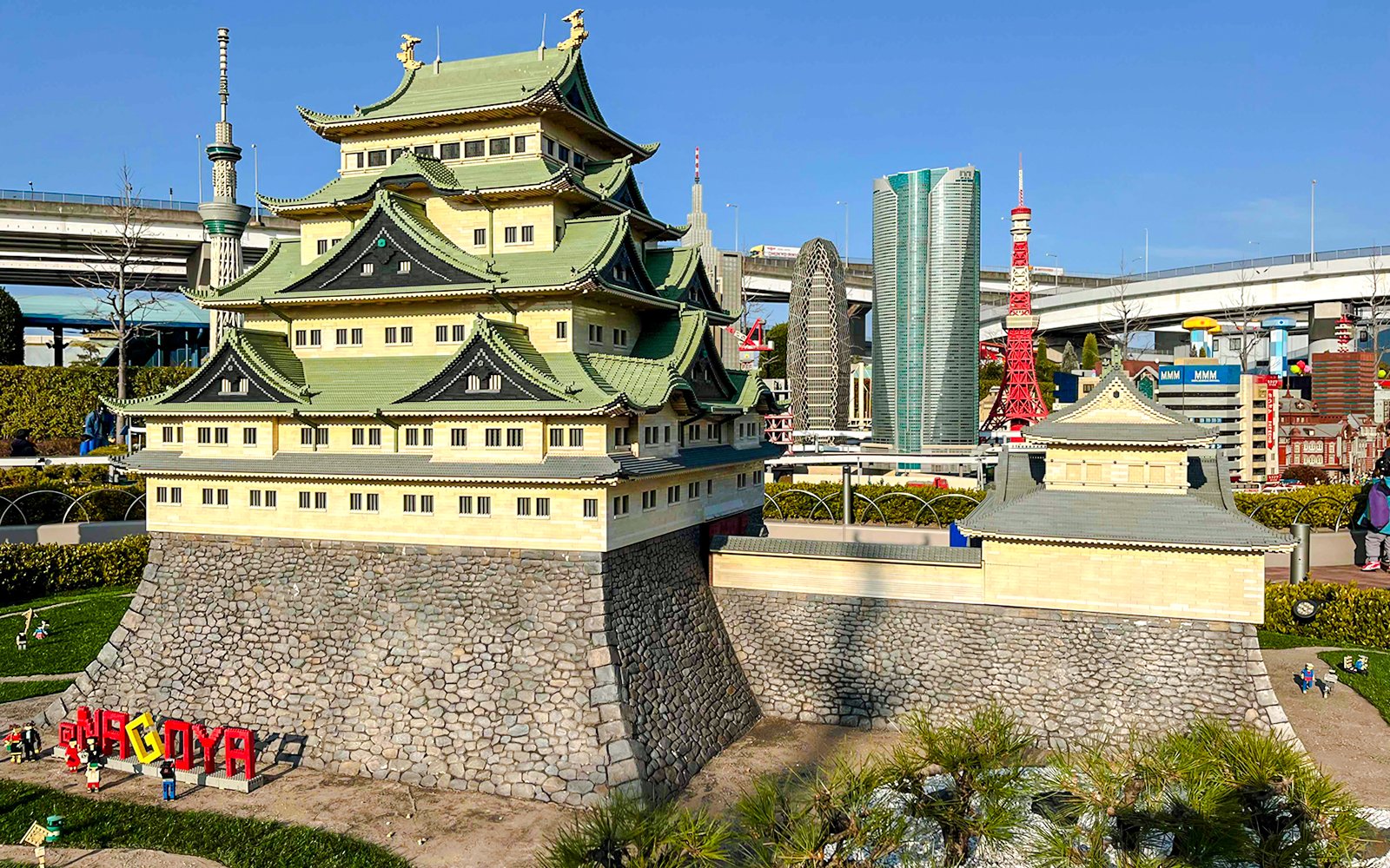 Lego model of Nagoya Castle at Legoland Japan with cityscape in the background.