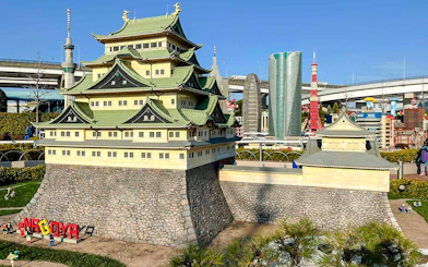 Lego model of Nagoya Castle at Legoland Japan with cityscape in the background.