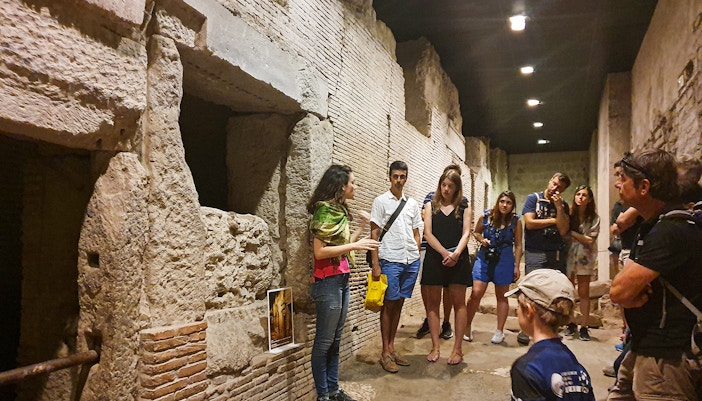 Naples underground with tourists exploring ancient underground ruins.