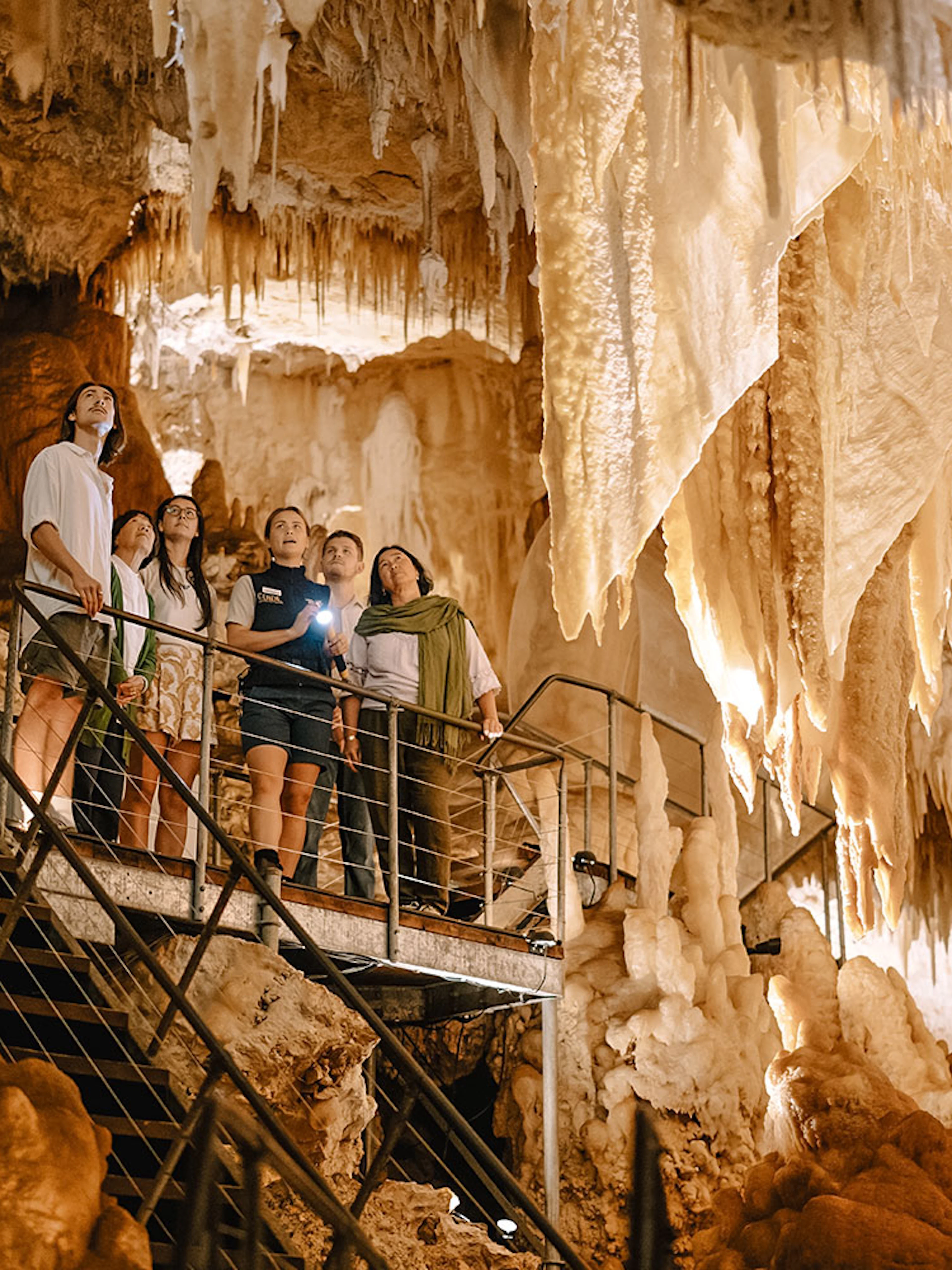Visitors exploring stalactites in Jewel Cave, Margaret River guided tour.