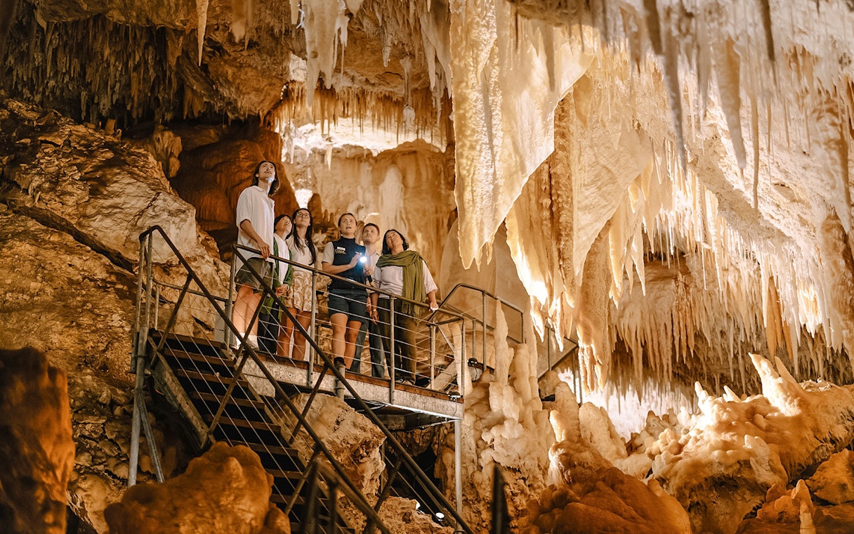 Visitors exploring stalactites in Jewel Cave, Margaret River guided tour.