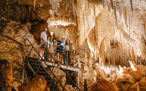 Visitors exploring stalactites in Jewel Cave, Margaret River guided tour.