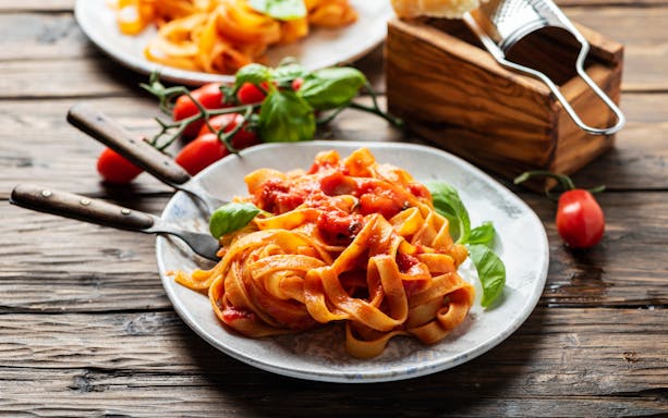 Fettuccine pasta being prepared in a cooking class in Rome, Italy.